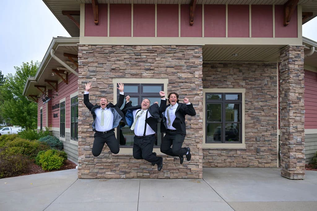 Dr. Christopher Carroll with Dr. Bryce Carroll and Dr. Joshua Carroll celebrating outside River Street Dental