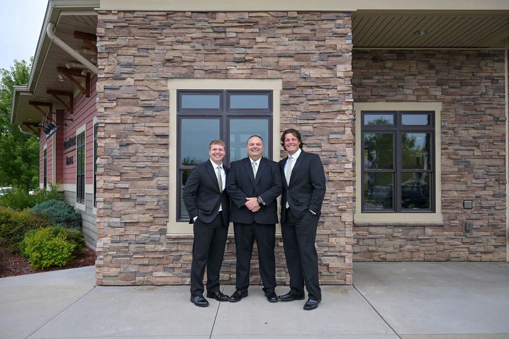 Dr. Christopher Carroll, Dr. Bryce Carroll, and Dr. Joshua Carroll outside River Street Dental